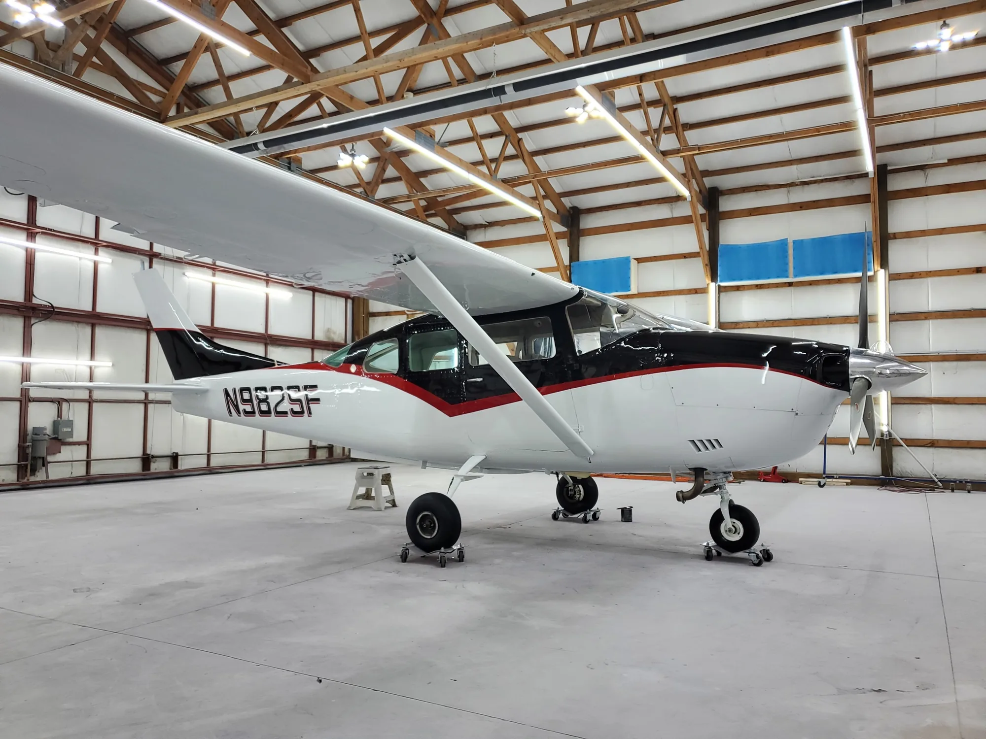 Black, red and white finished aircraft in the Hangar 74 shop