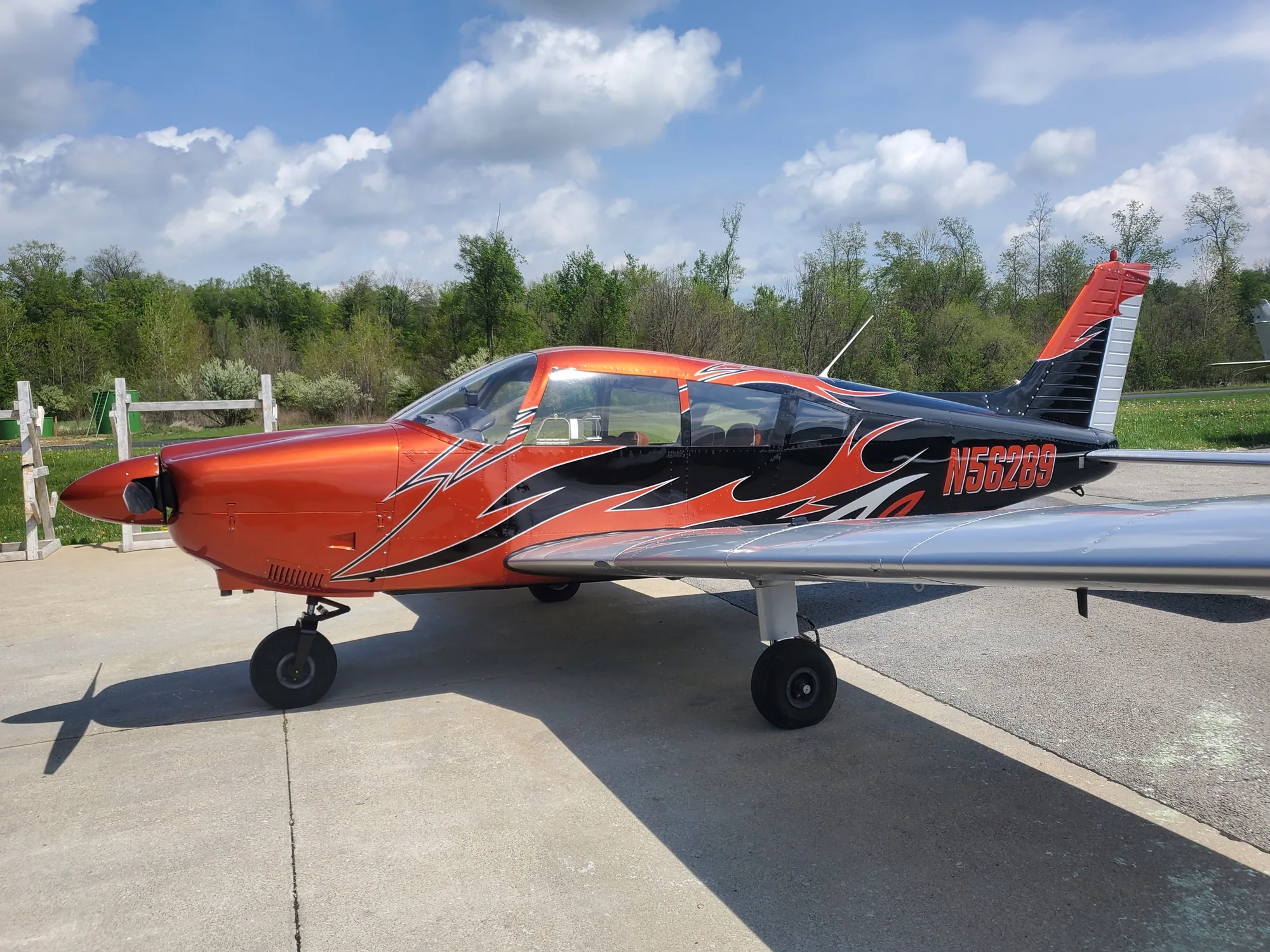 Flame-painted aircraft outside the Hangar 74 shop