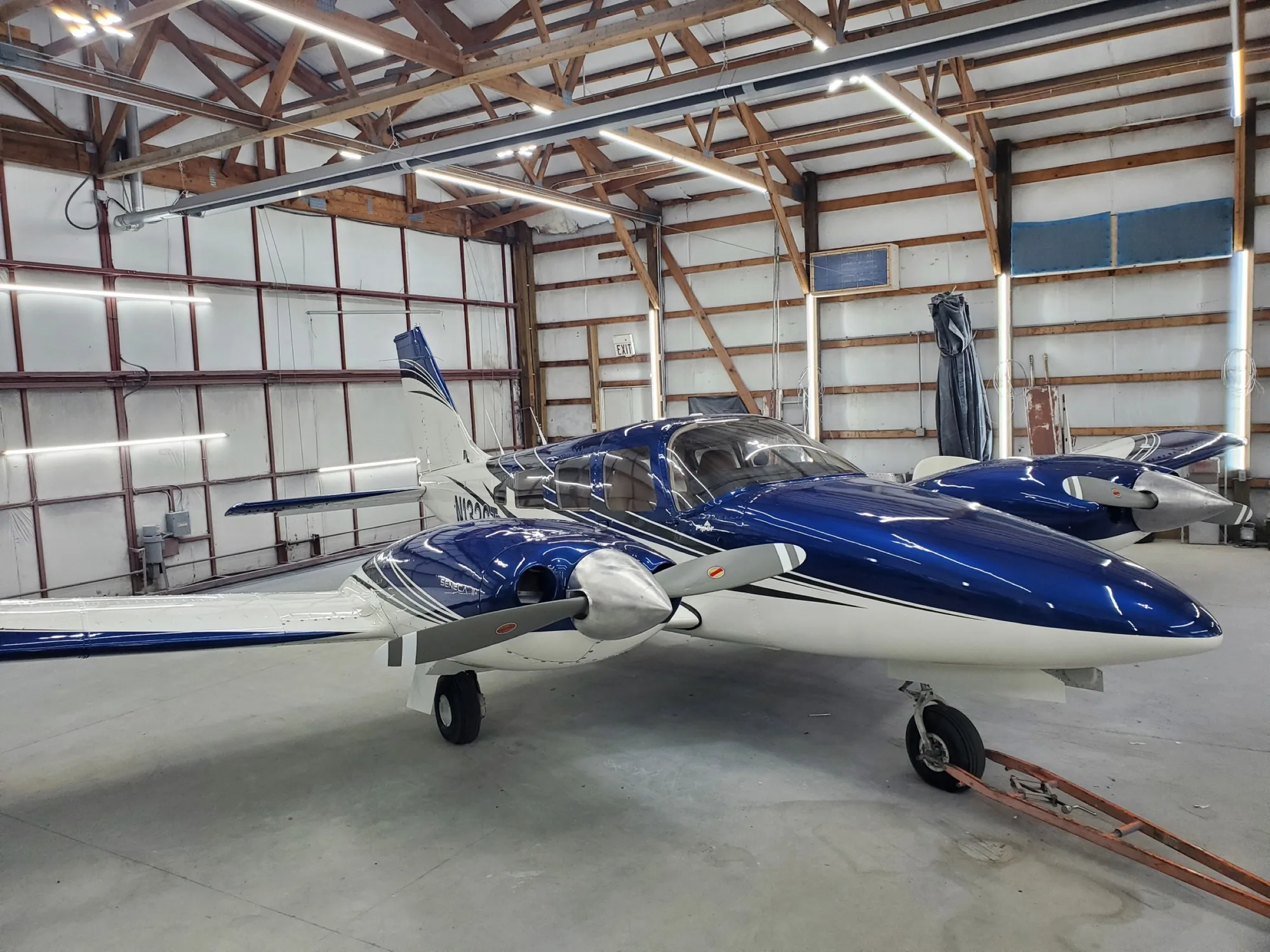 Glossy navy twin-engine aircraft refinished by Hangar 74