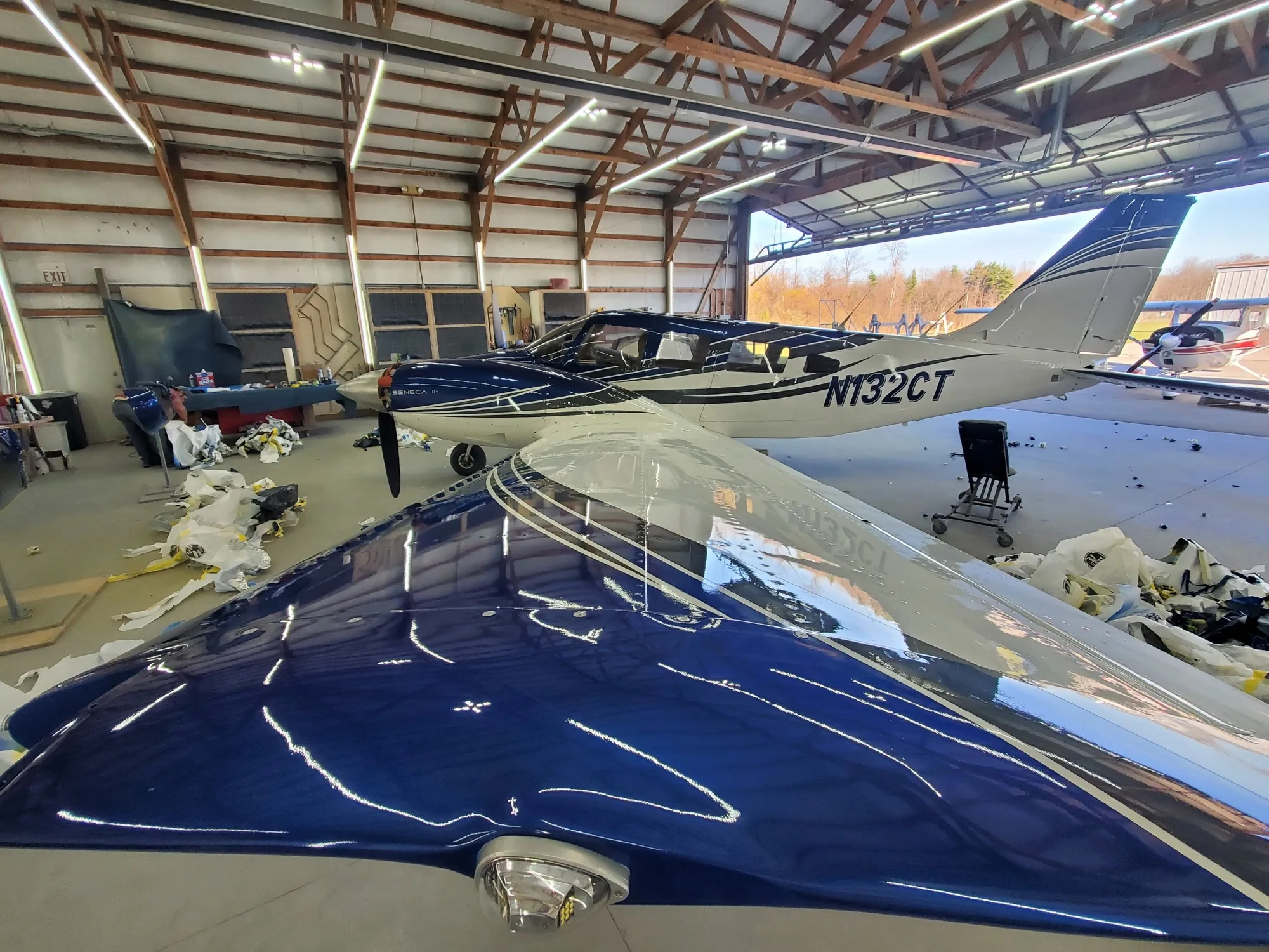 Freshly revealed glossy blue wing and completed aircraft in the Hangar 74 shop